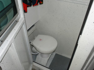 Stand-up head compartment with exterior vent, door & latch.